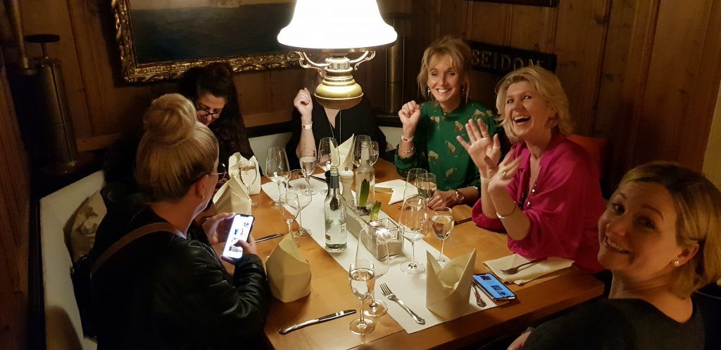 Eine Gruppe Frauen sitzt an einem Tisch in einem Restaurant.