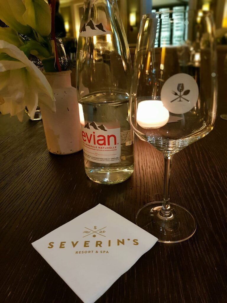 Ein Glas Wein und eine Serviette auf einem Tisch.