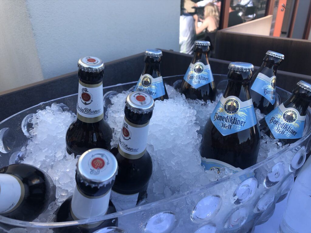 Eine Gruppe Bierflaschen liegt im Eis auf einem Tisch.